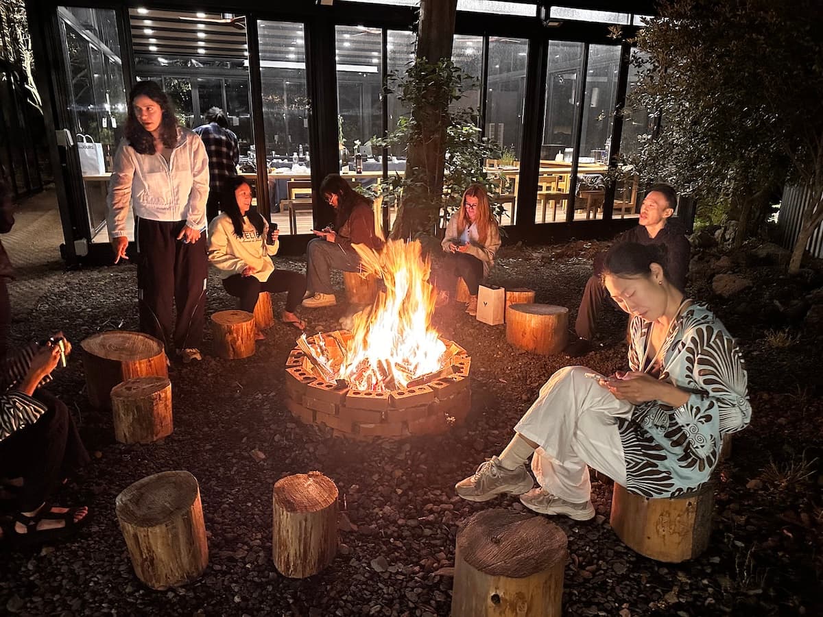 K-Pole Retreat participants enjoying their time together around a bond fire drinking and chatting.